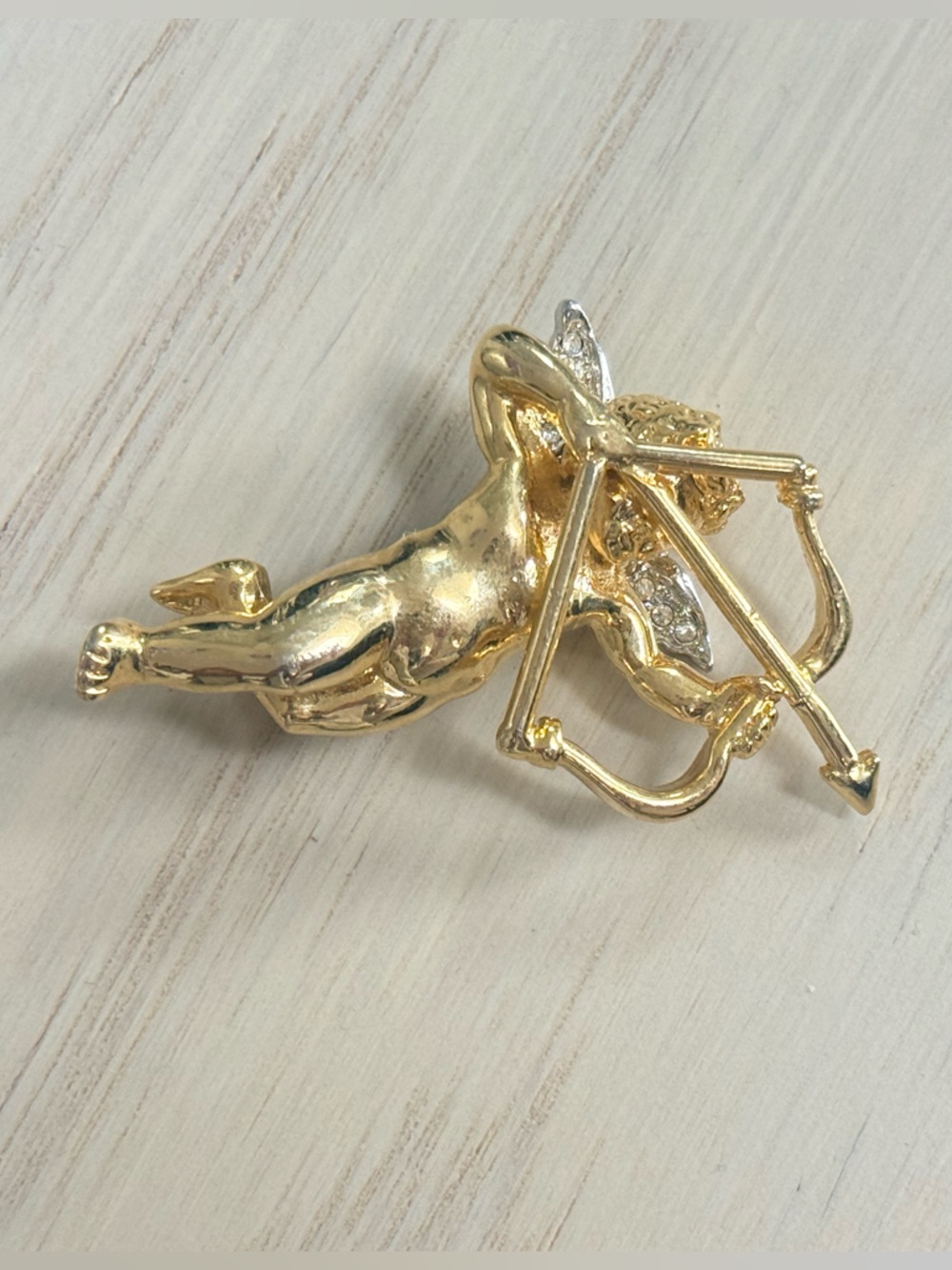 Gold-tone Cupid with Bow Brooch